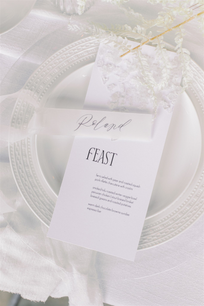 Minimalist menu with modern typography with a vellum (translucent) place card with modern artist style calligraphy